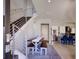 Light-filled entryway with modern staircase, dining area, and an open view of the kitchen at 3003 S Sherman St, Englewood, CO 80113