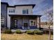 Modern two-story home with a stone facade, porch, fireplace and a manicured front yard at 3003 S Sherman St, Englewood, CO 80113