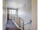 Upstairs hallway with sleek railings, and neutral tones, creating an inviting transition between rooms at 3003 S Sherman St, Englewood, CO 80113