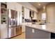 Modern kitchen with stainless steel appliances, white cabinets, and a center island at 3003 S Sherman St, Englewood, CO 80113