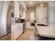 Bright kitchen with white cabinets, stainless steel appliances, and hardwood floors at 3003 S Sherman St, Englewood, CO 80113