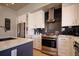 Well-equipped kitchen with stainless steel appliances, white cabinets, and modern finishes at 3003 S Sherman St, Englewood, CO 80113