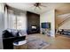 Cozy living room featuring a modern fireplace, sleek TV console, and an open staircase at 3003 S Sherman St, Englewood, CO 80113