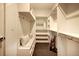 Spacious walk-in closet with custom shelving and a built-in bench for convenient storage at 3003 S Sherman St, Englewood, CO 80113