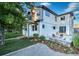 Well-maintained backyard featuring a patio with fire pit, lush green lawn, and beautiful landscaping at 2182 S Ogden St, Denver, CO 80210