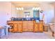 Bathroom showcasing double sink vanity, marble floors, soaking tub, and glass shower at 2182 S Ogden St, Denver, CO 80210