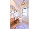 Stylish powder room features modern vanity, gold fixtures, round mirror, and patterned floor tile at 2182 S Ogden St, Denver, CO 80210