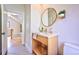 Stylish powder room features modern vanity, gold fixtures, round mirror, and patterned floor tile at 2182 S Ogden St, Denver, CO 80210