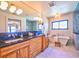 Beautiful bathroom featuring double sink vanity, a soaking tub, and separate glass shower at 2182 S Ogden St, Denver, CO 80210