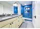 Modern bathroom with a double vanity and an elegant blue-tiled walk-in shower at 2182 S Ogden St, Denver, CO 80210