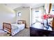 Comfortable bedroom with a cozy bed, accent chair, and dresser with fresh flowers at 2182 S Ogden St, Denver, CO 80210