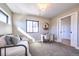 The bedroom includes natural lighting from window and desk with a stylish chandelier at 2182 S Ogden St, Denver, CO 80210
