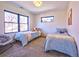 This carpeted shared bedroom features two beds and a brightly lit window at 2182 S Ogden St, Denver, CO 80210