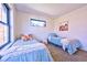 This shared bedroom features an open window and decor with twin beds at 2182 S Ogden St, Denver, CO 80210