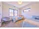 This shared bedroom features two beds, a reading chair, and a bright window at 2182 S Ogden St, Denver, CO 80210