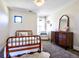 Cozy bedroom with a wood framed bed, vintage dresser, and a reading chair at 2182 S Ogden St, Denver, CO 80210