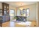 Dining area features wood table, chandelier, built-in cabinet, and lots of natural light at 2182 S Ogden St, Denver, CO 80210