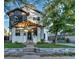 Charming two-story home with beautiful brick and siding, a covered front porch, and landscaped front yard at 2182 S Ogden St, Denver, CO 80210