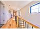 Bright hallway features hardwood floors, windows, and a staircase with wooden handrail at 2182 S Ogden St, Denver, CO 80210
