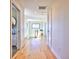 Hallway features wood floors, white walls, and plenty of natural light from the window at 2182 S Ogden St, Denver, CO 80210