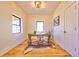 Bright home office with hardwood floors, statement lighting, window with a view, and a hide rug at 2182 S Ogden St, Denver, CO 80210