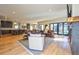 Expansive living area with hardwood floors, living room, kitchen, and access to outdoor patio at 2182 S Ogden St, Denver, CO 80210