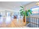 Open-concept living area with hardwood floors, staircase, and living area leading to the back patio at 2182 S Ogden St, Denver, CO 80210