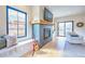 Cozy living room features a fireplace, hardwood floors, built-in seating, and large window views at 2182 S Ogden St, Denver, CO 80210