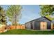 Exterior view of a large shed with natural wood doors and a fenced yard at 2182 S Ogden St, Denver, CO 80210