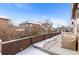 Covered patio with space for seating and snow covered ground at 3953 Blue Pine Cir, Highlands Ranch, CO 80126