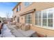 Back patio with covered seating and access to the house at 3953 Blue Pine Cir, Highlands Ranch, CO 80126