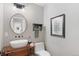 Elegant powder room with a modern vessel sink and antique vanity at 3953 Blue Pine Cir, Highlands Ranch, CO 80126