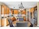 Bright kitchen with an island, wood cabinets, and tile backsplash at 3953 Blue Pine Cir, Highlands Ranch, CO 80126