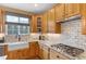 Modern kitchen with a farmhouse sink and gas cooktop at 3953 Blue Pine Cir, Highlands Ranch, CO 80126