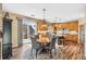 Open kitchen features wood cabinets, tile flooring, and access to backyard at 3953 Blue Pine Cir, Highlands Ranch, CO 80126