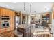 Spacious kitchen with an island, stainless steel appliances, and wood cabinets at 3953 Blue Pine Cir, Highlands Ranch, CO 80126