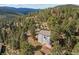 Aerial view of the home surrounded by lush greenery at 6904 Sprucedale Pkwy, Evergreen, CO 80439