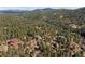 Aerial view of homes nestled in lush greenery at 6904 Sprucedale Pkwy, Evergreen, CO 80439