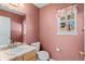 Cozy bathroom with pink walls and a marble countertop vanity at 6904 Sprucedale Pkwy, Evergreen, CO 80439