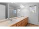 Bathroom featuring double sink vanity and walk-in shower at 6904 Sprucedale Pkwy, Evergreen, CO 80439