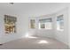 Spacious bedroom featuring large windows and light colored carpet at 6904 Sprucedale Pkwy, Evergreen, CO 80439
