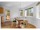Dining area featuring a wooden table with seating for four and large windows offering natural light at 6904 Sprucedale Pkwy, Evergreen, CO 80439
