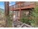 Multi-level deck showcasing architectural design and blending seamlessly with the forest landscape at 6904 Sprucedale Pkwy, Evergreen, CO 80439