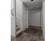 Hallway with slate flooring leading to stairs with a white banister and a closet at 6904 Sprucedale Park Way, Evergreen, CO 80439