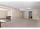 Spacious living room with beige carpet and views into office and bedroom at 6904 Sprucedale Pkwy, Evergreen, CO 80439