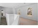 Bright upstairs loft with arched windows and neutral carpet at 6904 Sprucedale Pkwy, Evergreen, CO 80439