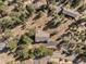 Aerial view of a home nestled in a forest, featuring long driveway, and lush surroundings at 6904 Sprucedale Pkwy, Evergreen, CO 80439