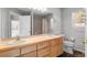 Bathroom featuring double sinks, a large mirror, and a shower/tub combination at 6904 Sprucedale Pkwy, Evergreen, CO 80439