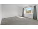 Bright and spacious bedroom with a large window offering scenic views at 6904 Sprucedale Pkwy, Evergreen, CO 80439