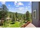 Deck offers stunning views of the lush green landscape and clear blue sky at 6904 Sprucedale Pkwy, Evergreen, CO 80439